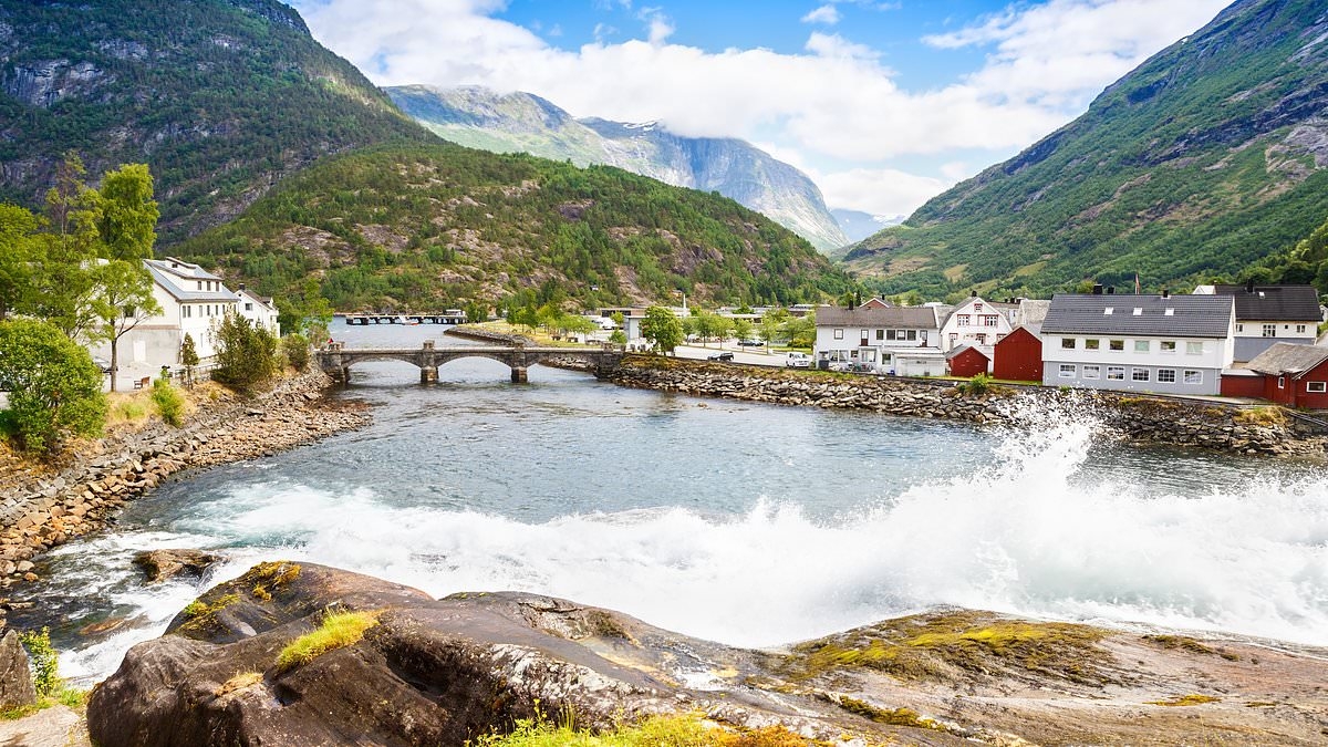 The European village visited by thousands of tourists a day and loved by filmmakers - but could one day be destroyed by 'the world's tallest tsunami'