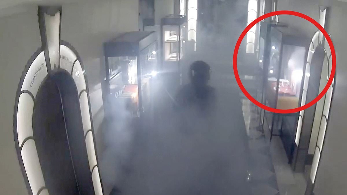 Terrifying moment jewel thief fired up smoke grenades in Claridge's and smashed his way into display case in £190,000 raid before hero security guard grabbed him