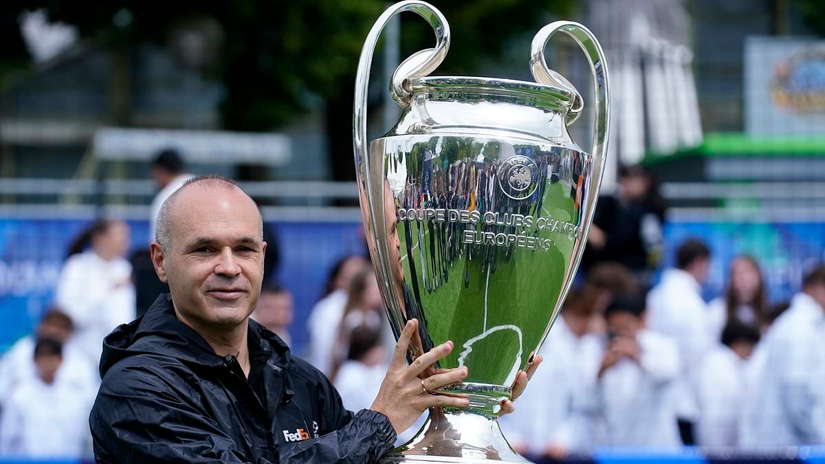 Barcelona legend Andres Iniesta sends fans into a frenzy as he delivers the Champions League trophy to Munich ahead of the final between PSG and Inter Milan