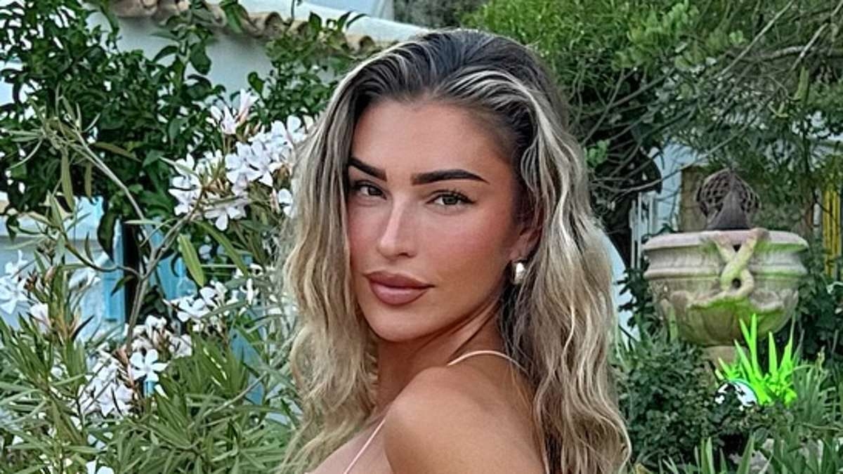 Zara McDermott stuns in a backless pink dress as she arrives in Ibiza after her loved-up getaway with boyfriend Louis Tomlinson