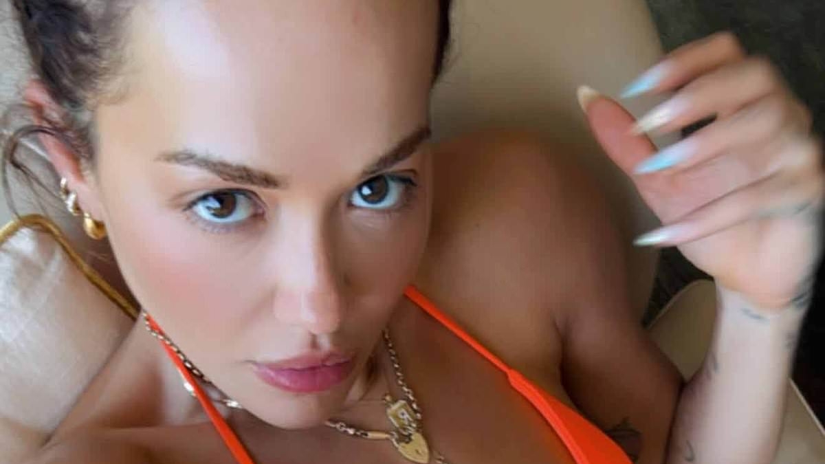 Rita Ora juices new single with sexy snap in orange bikini and statement necklace