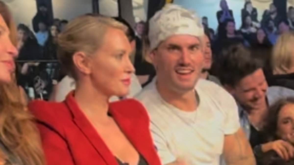 Love Island Australia's Taylor Reid, 28, enjoys date night with his 'forever hall pass' Nicky Whelan, 44 - as the unlikely duo cosy up ringside at star-studded Melbourne event