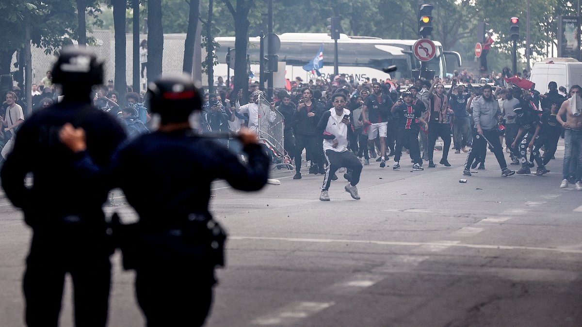 PSG's Champions League parade turns nasty: Fans clash with riot police in more chaotic scenes as Emmanuel Macron condemns violence that left two people dead and hundreds injured