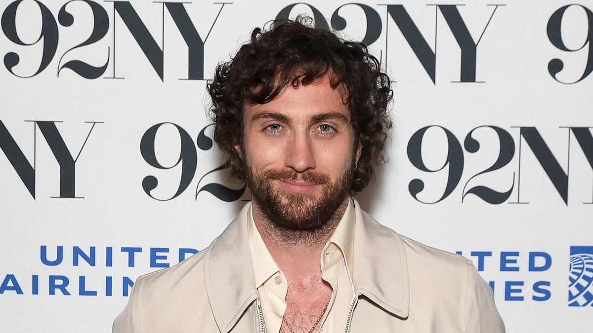 Aaron Taylor-Johnson smoulders as he flashes a glimpse of his hairy chest in an open shirt alongside Jodie Comer and director Danny Boyle at 28 Years Later event in NYC