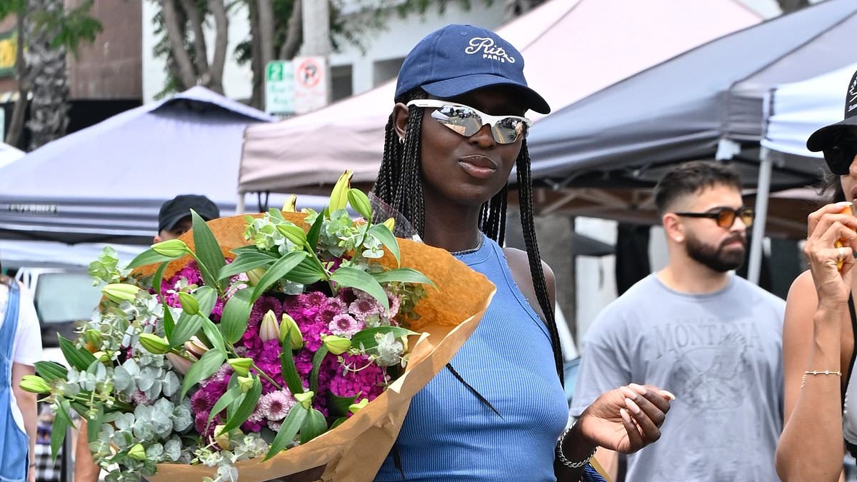 Jodie Turner-Smith flashes her abs in a crop top and denim shorts as she shops for fresh flowers in LA