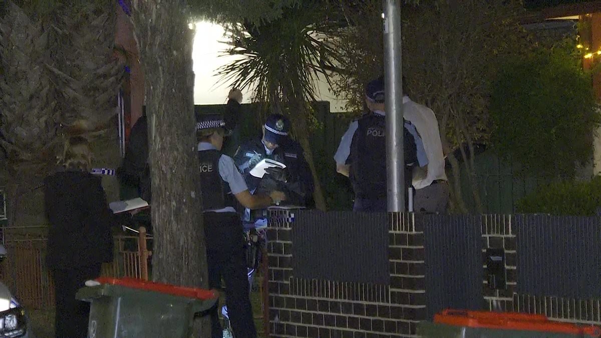 BREAKING NEWS Police swarm a home in Sydney's inner-west to find a man dead with stab wounds - as an arrest is made at the property