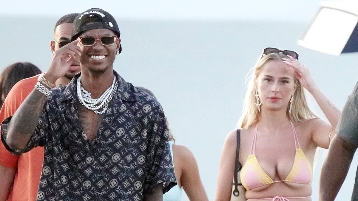 Marcus Rashford spotted with a mystery blonde on a lavish Saint-Tropez getaway, wearing TWO luxury watches, a full Louis Vuitton outfit and carrying tobacco pouches as he waits for Man United transfer