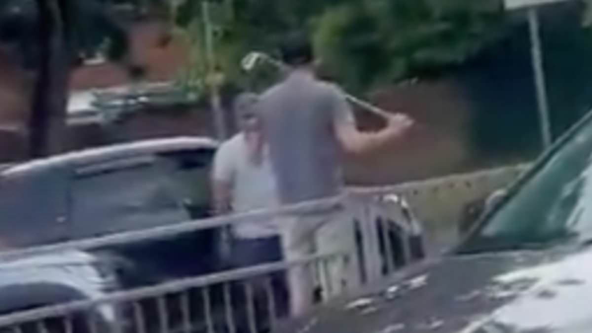 Moment angry driver gets in road rage row with rival motorist while armed with golf club