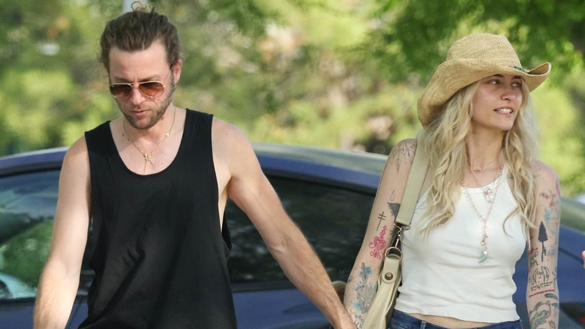 Paris Jackson goes bra-free in a skimpy tank top as she holds hands with fiance Justin Long