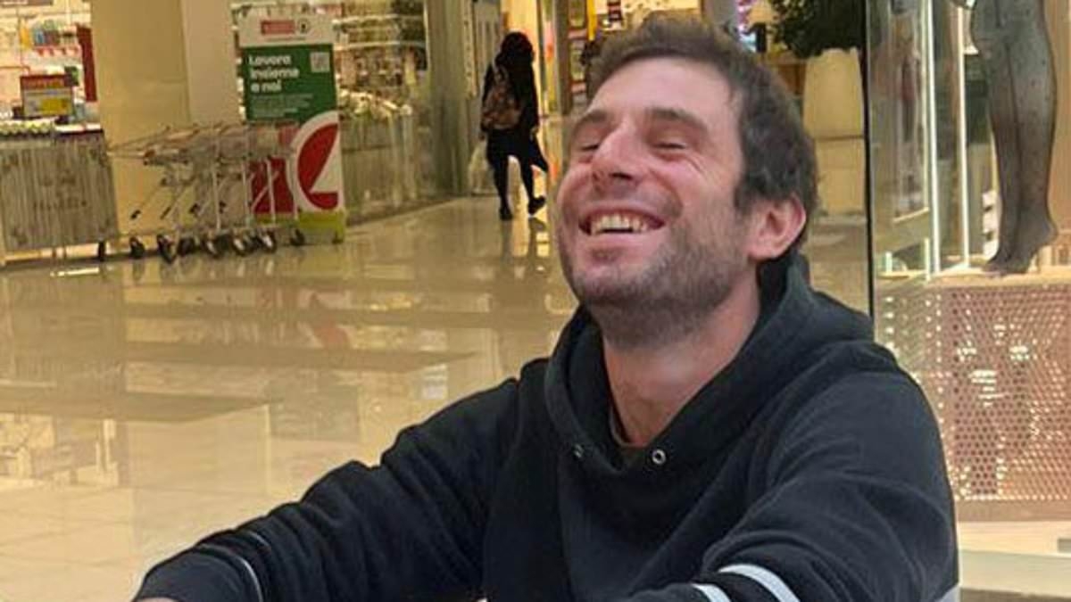 Grieving father unlocks his son's phone a year after his death to find a video of 'the killer wearing a mocking grin moments after the stabbing'
