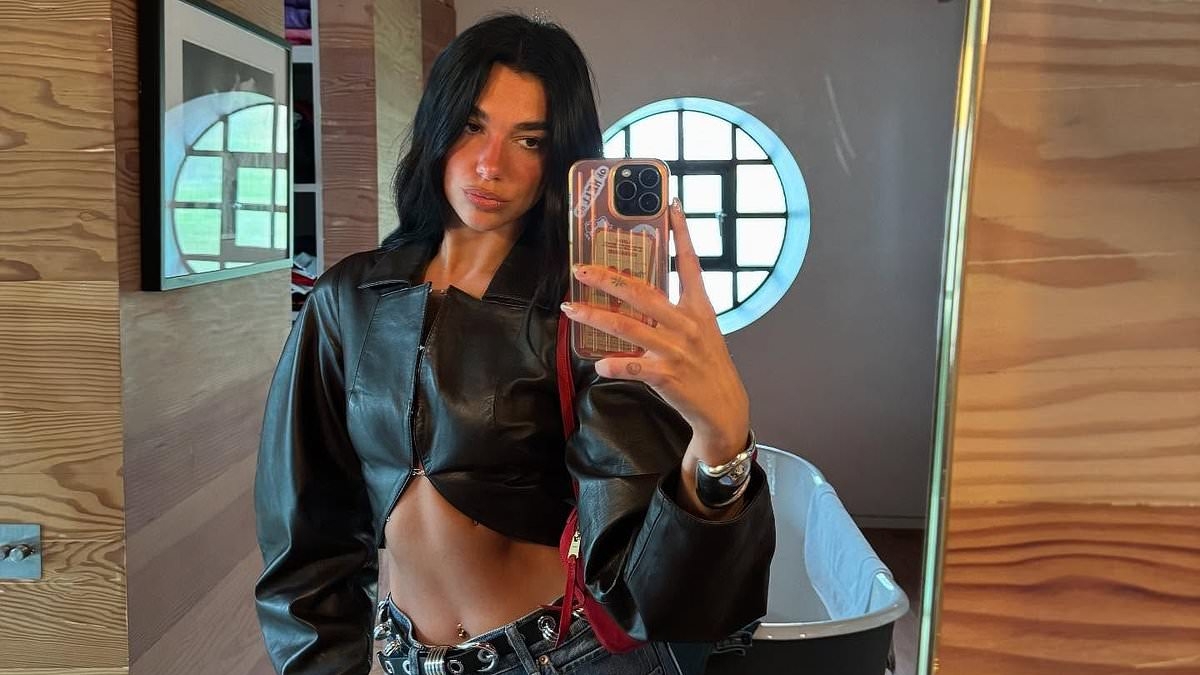Dua Lipa flaunts her washboard abs in a cropped black leather jacket before changing into leggings for yoga class
