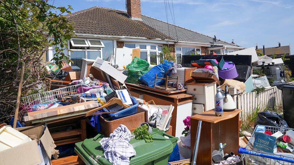 Hoarder threatened with council action after mountain of rubbish, broken furniture and trolley full of groceries piles high in her front garden