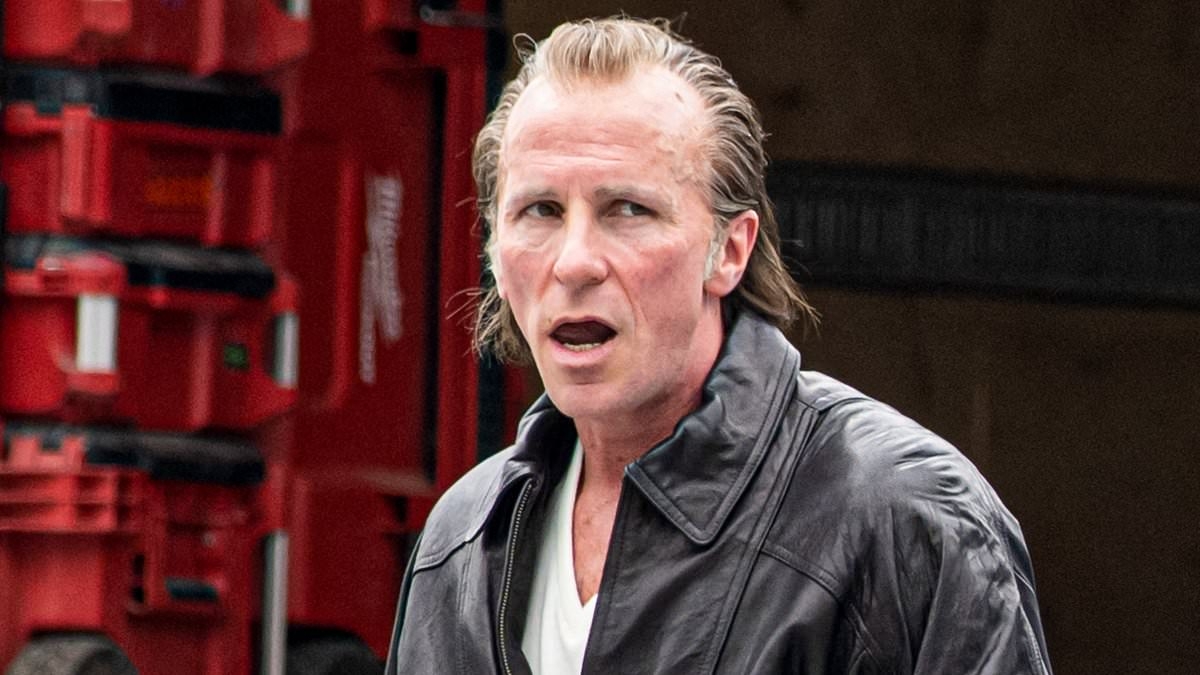 Hollywood legend, 51, looks unrecognisable on the set of new NFL movie - but can YOU guess who it is?