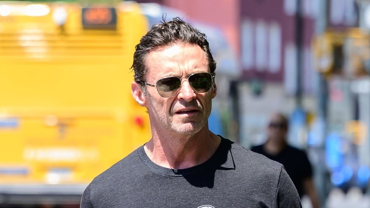 Hugh Jackman snaps selfies with fans as he leaves the theatre amid reports ex Deborra-Lee Furness is 'planning to release divorce tell-all'