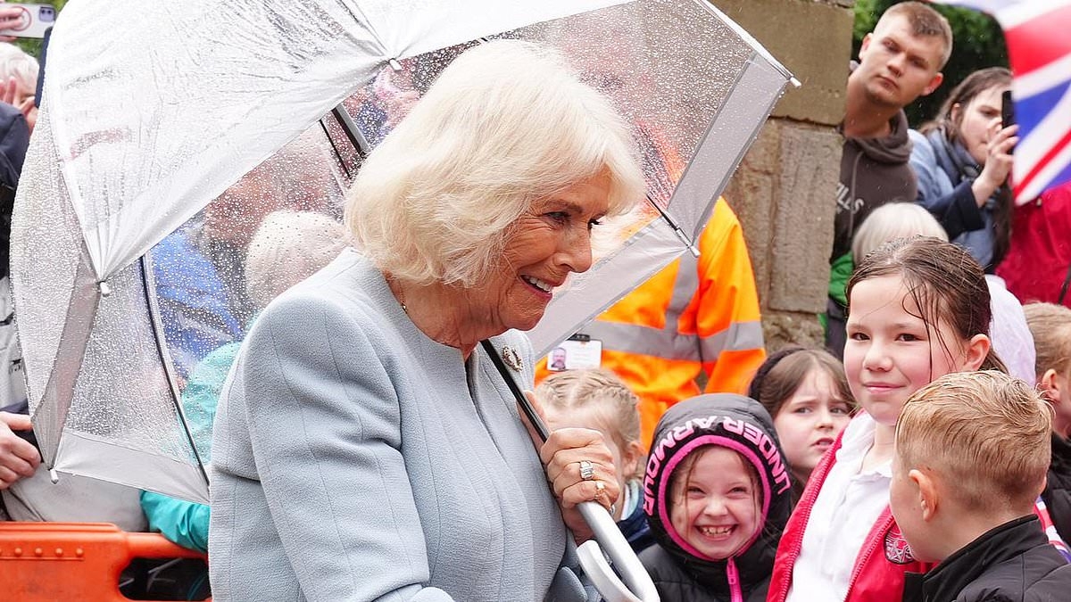 Queen Camilla refuses to let the rainy weather dampen her spirits as she visits 'the most beautiful racecourse'