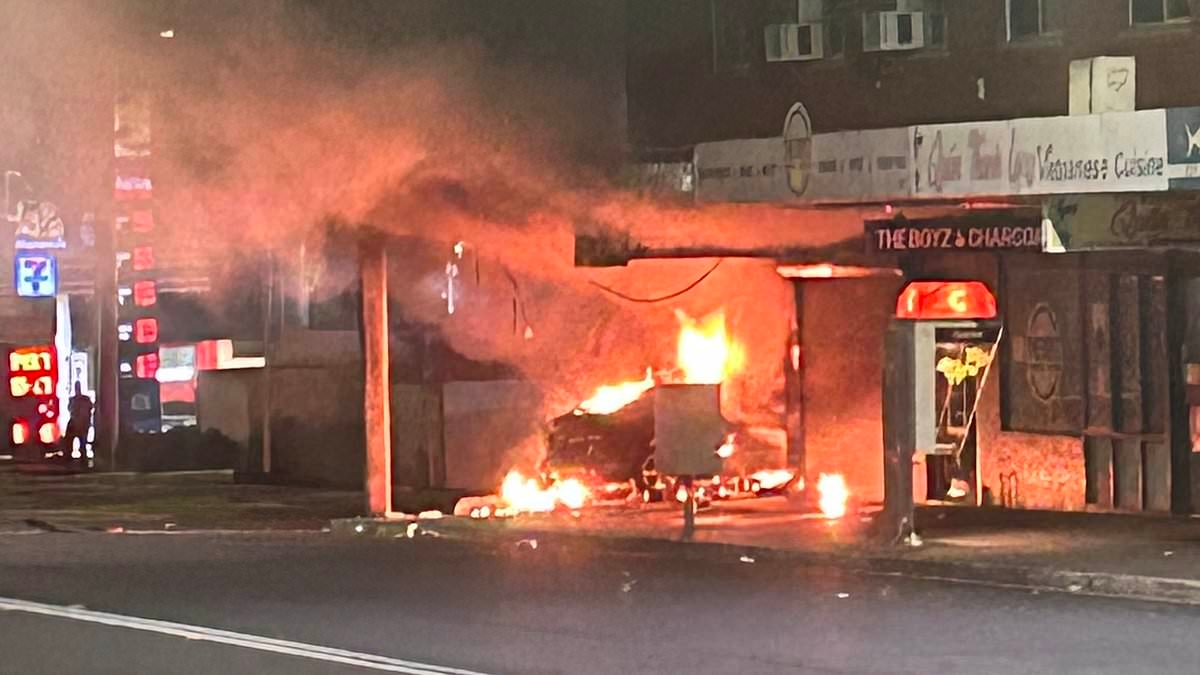 BREAKING NEWS Manhunt after black sedan rams into a corner store targeted three times in SIX weeks - as residents wake to screams and a 'loud boom'