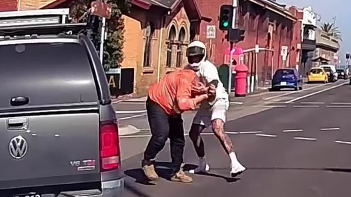 Wild moment tattooed scooter rider erupts at driver in fiery clash after he was sent flying off his bike