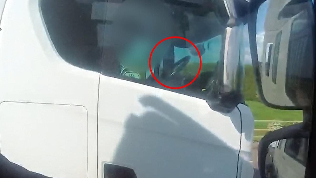 Shocking moment lorry driver is caught with no hands on the wheel as he rolls a cigarette on the motorway