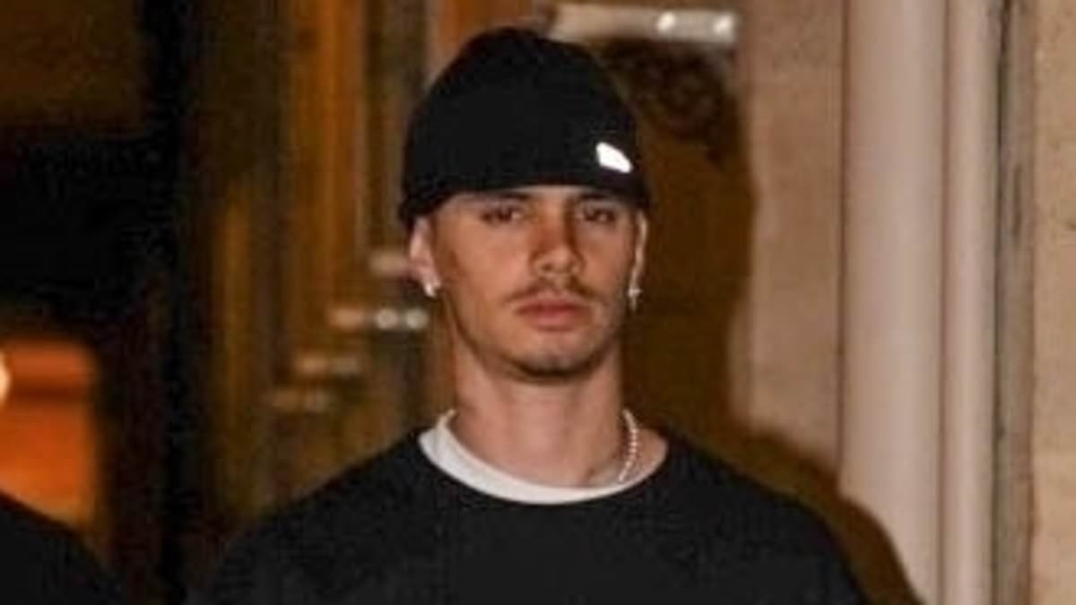 Newly-single Romeo Beckham cuts a sombre figure as he heads out in Paris following shock split from Kim Turnbull