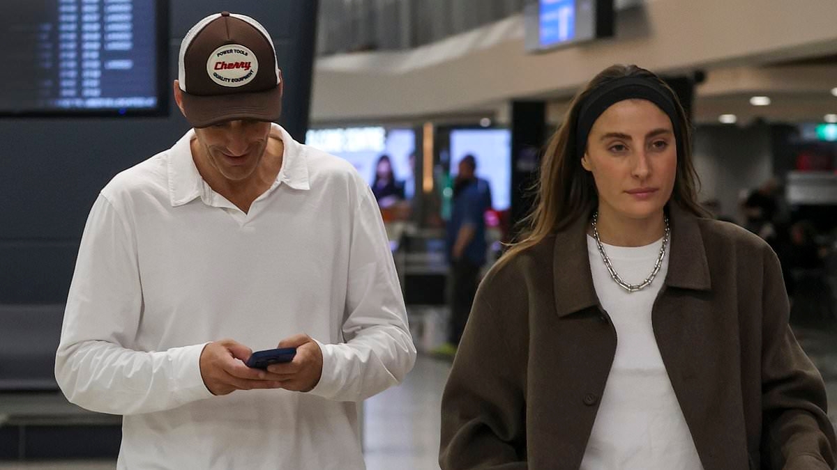 Andy Lee and Rebecca Harding spotted jetting into Melbourne after New York trip...as the comedian goes straight back to 'work' on mammoth mansion project