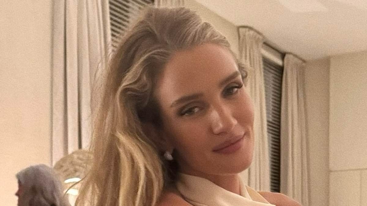 Braless Rosie Huntington-Whiteley puts on a leggy display in a satin mini dress as she cosies up to fiancé Jason Statham during lavish Antwerp trip