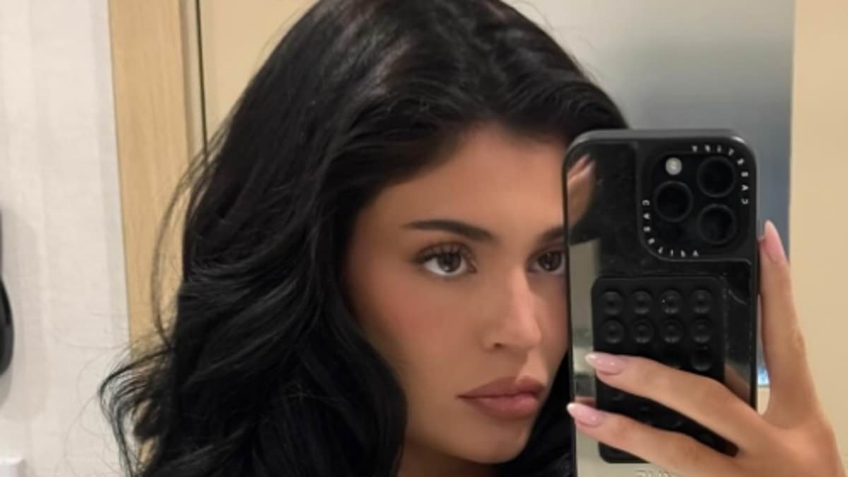 Kylie Jenner goes topless under sexy black robe after shock admission about her breast implants