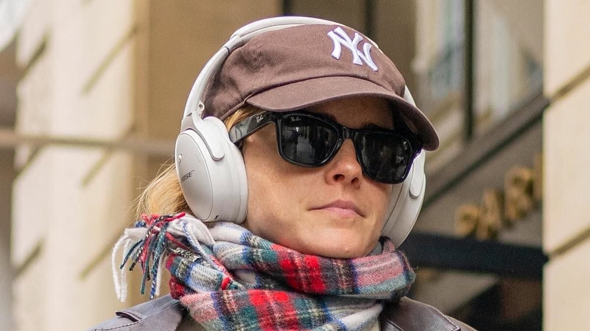 Emma Watson looks casually chic in a brown leather jacket and baggy jeans as she enjoys low key outing in Paris