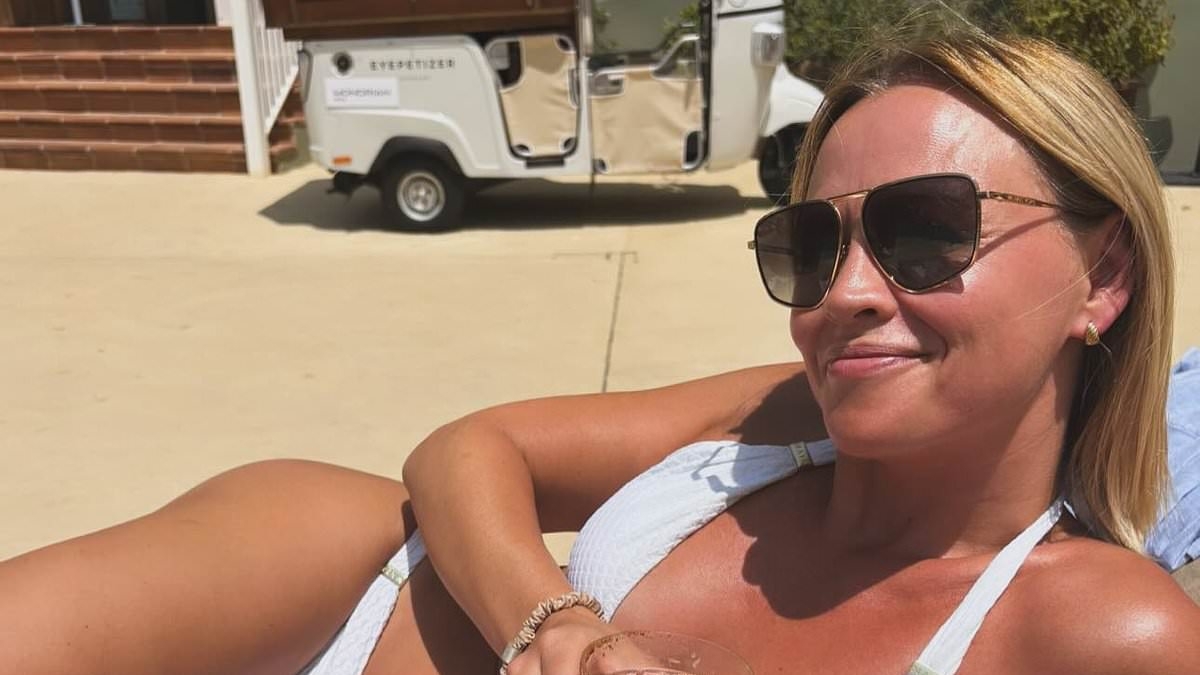 Kimberley Walsh shows off her figure in a plunging bikini as she lounges by the pool during girls trip to Ibiza