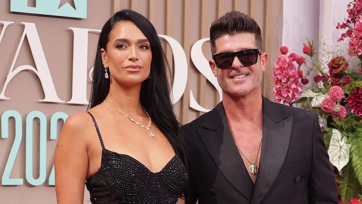 Robin Thicke and April Love Geary flash wedding bands for FIRST time... as his includes a VERY unusual surprise
