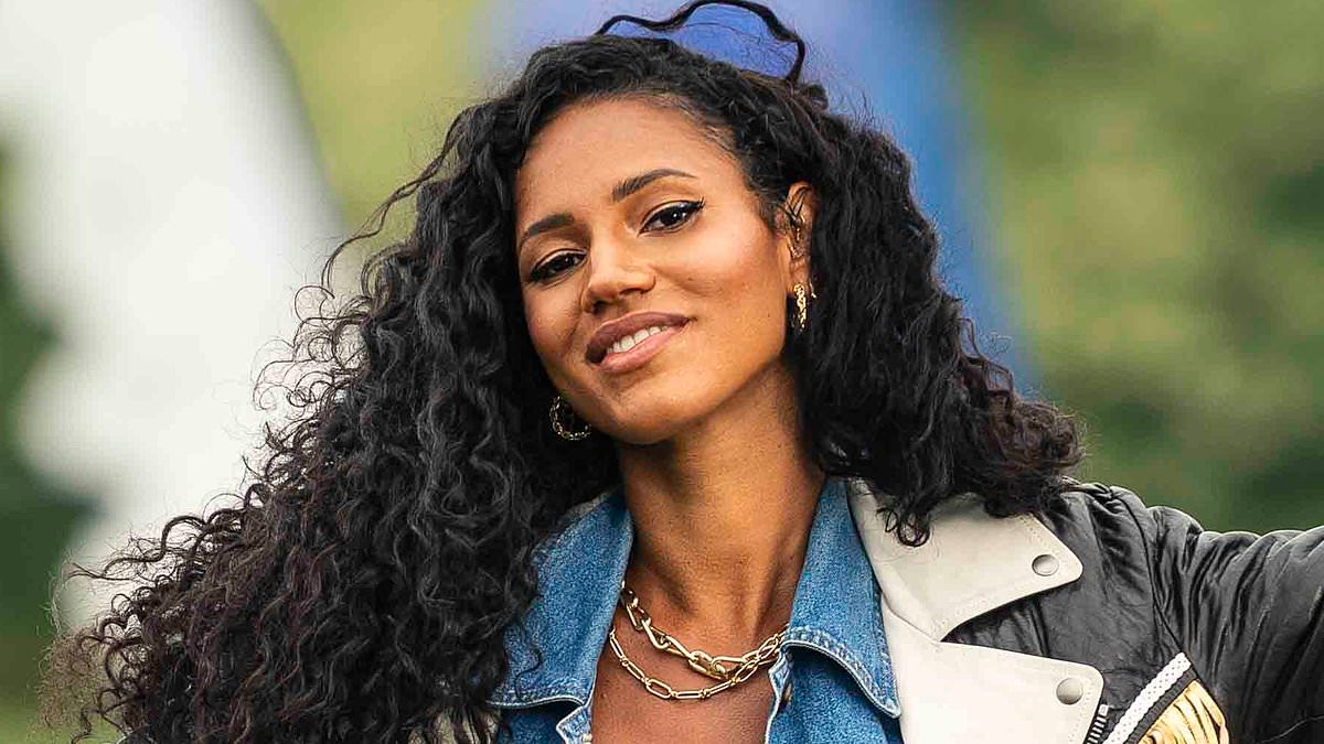 Pregnant Vick Hope shows off her baby bump in a vibrant yellow and red striped mini dress as she poses for new campaign