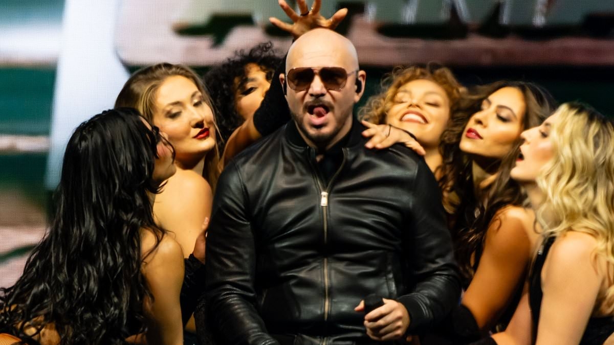 Pitbull makes epic return to London's O2 with two more energetic shows alongside his scantily-clad dancers - as fans continue tradition of dressing up as him for the concerts