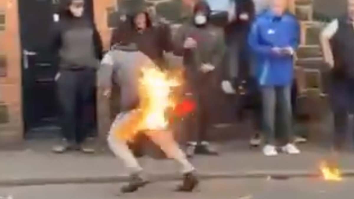 Instant karma! Shocking moment Ballymena rioter sets HIMSELF on fire with petrol bomb as police vow more arrests and consider bringing in fresh troops from England and Wales after second night of rioting
