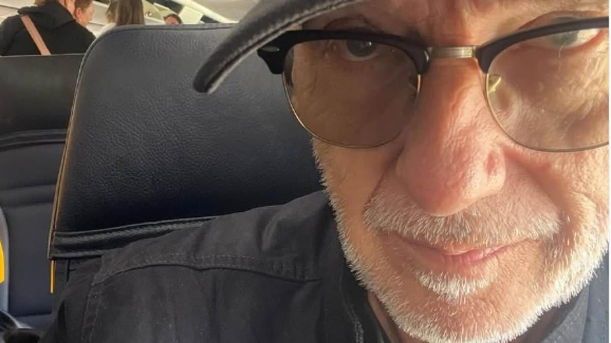 80s pop icon who penned smash hit Christmas song is unrecognisable as he boards budget RyanAir flight - but can YOU guess who it is?