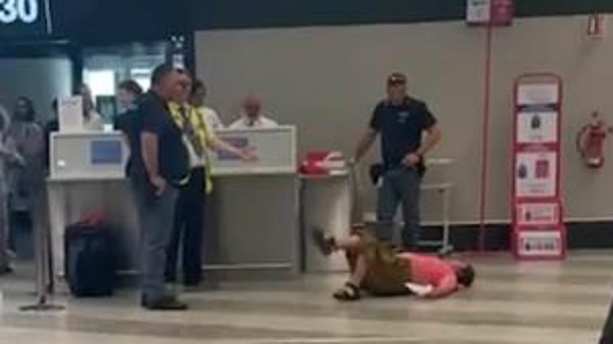 Meltdown in Milan! Tourist throws herself on the floor after being told her hand luggage was too heavy