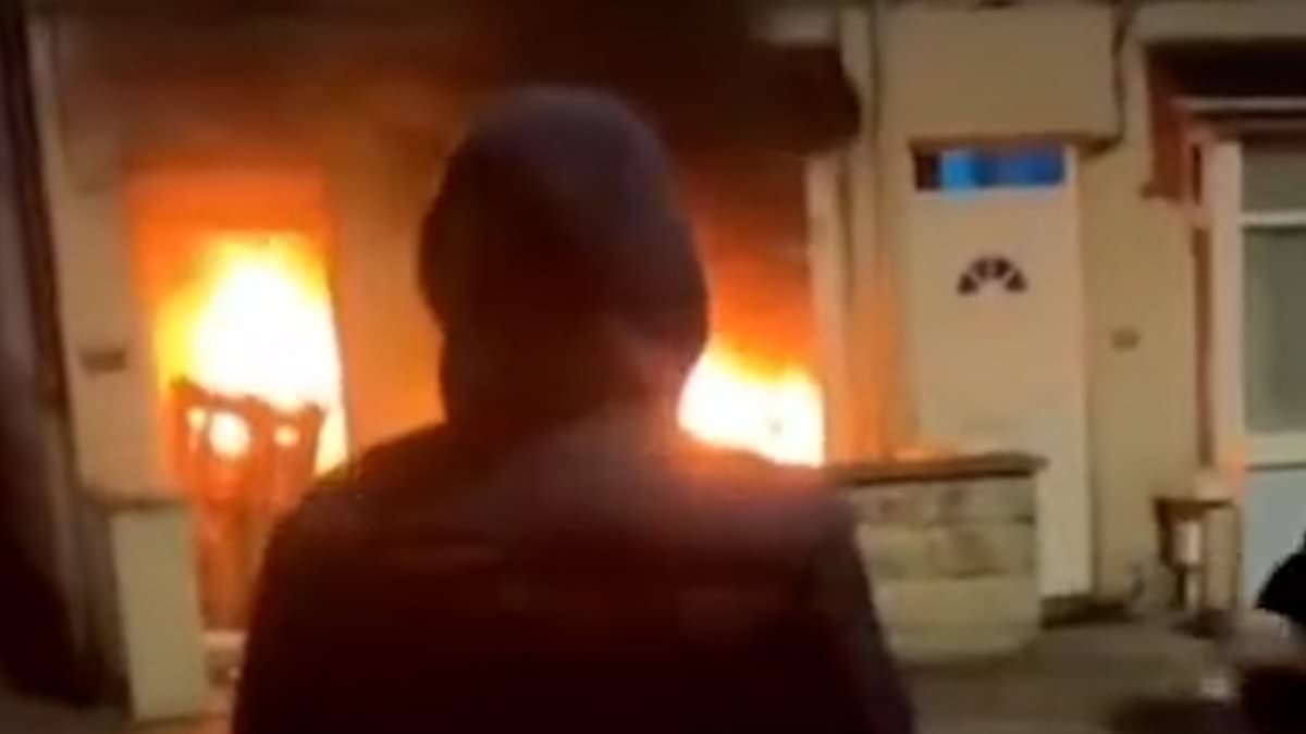 Rioters livestream themselves burning down a HOUSE on TikTok in Balleymena after 'Romanian' teens 'tried to rape girl' - as town braces for third night of carnage