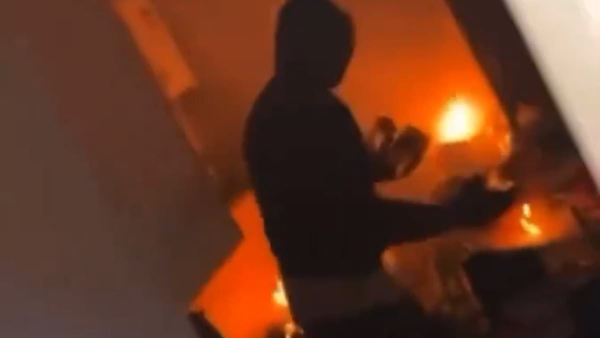 EXCLUSIVE Anti-migrant rioters shouting 'f*** off foreigners!' storm house in Ballymena and set it on fire as terrified locals put up signs showing nationality and refuge centre sheltering families is torched