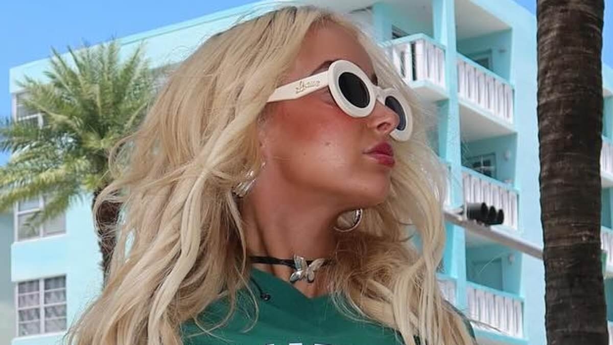 Guess who? Aussie star turns up the heat as she flaunts peachy derrière in daring mini-skirt while on holiday in Miami