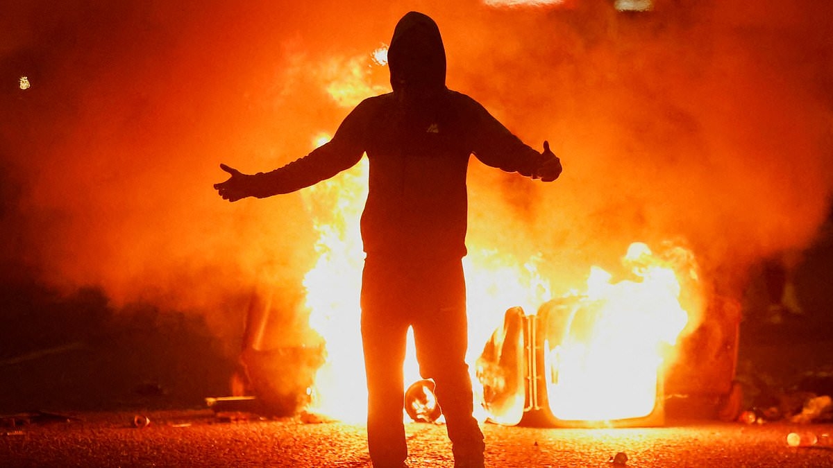 Riots spread in Northern Ireland with 15 arrested after nights of chaos following 'sexual assault of girl by Romanian teens' in Ballymena - as terrified foreign nationals consider fleeing