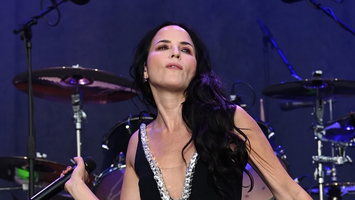 Andrea Corr, 51, has barely aged a day as she performs in plunging black mini dress with The Corrs in Halifax