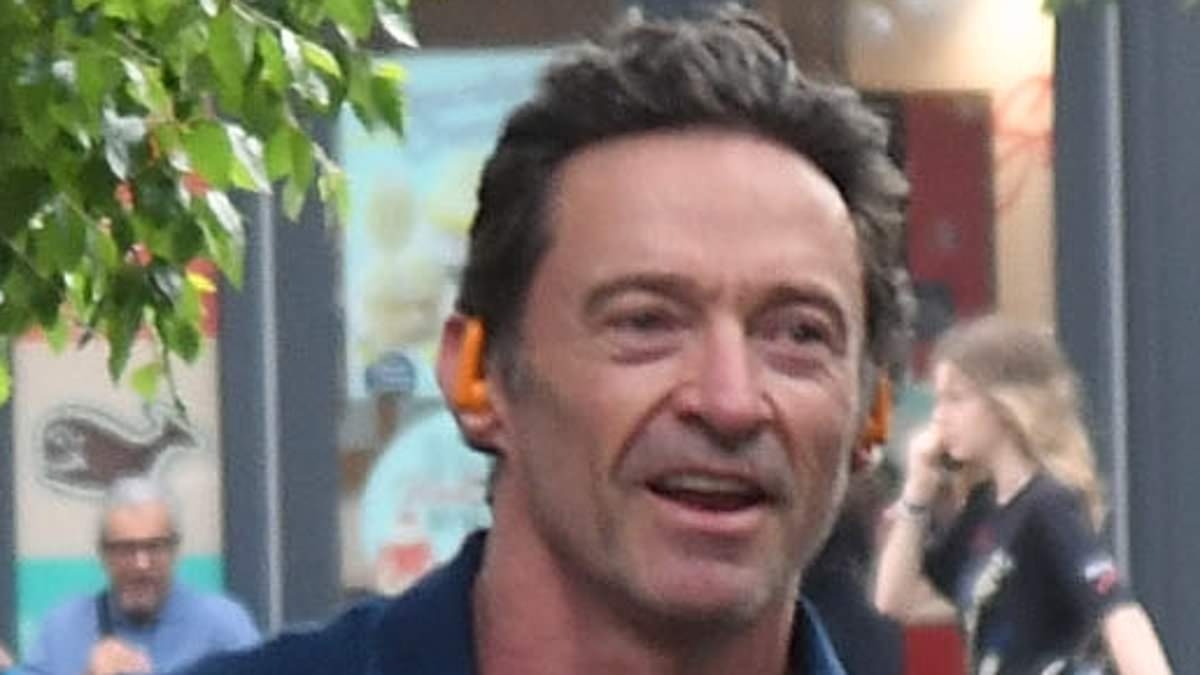 Hugh Jackman looks every inch the action star as he flaunts his bulging biceps while arriving at a New York theatre