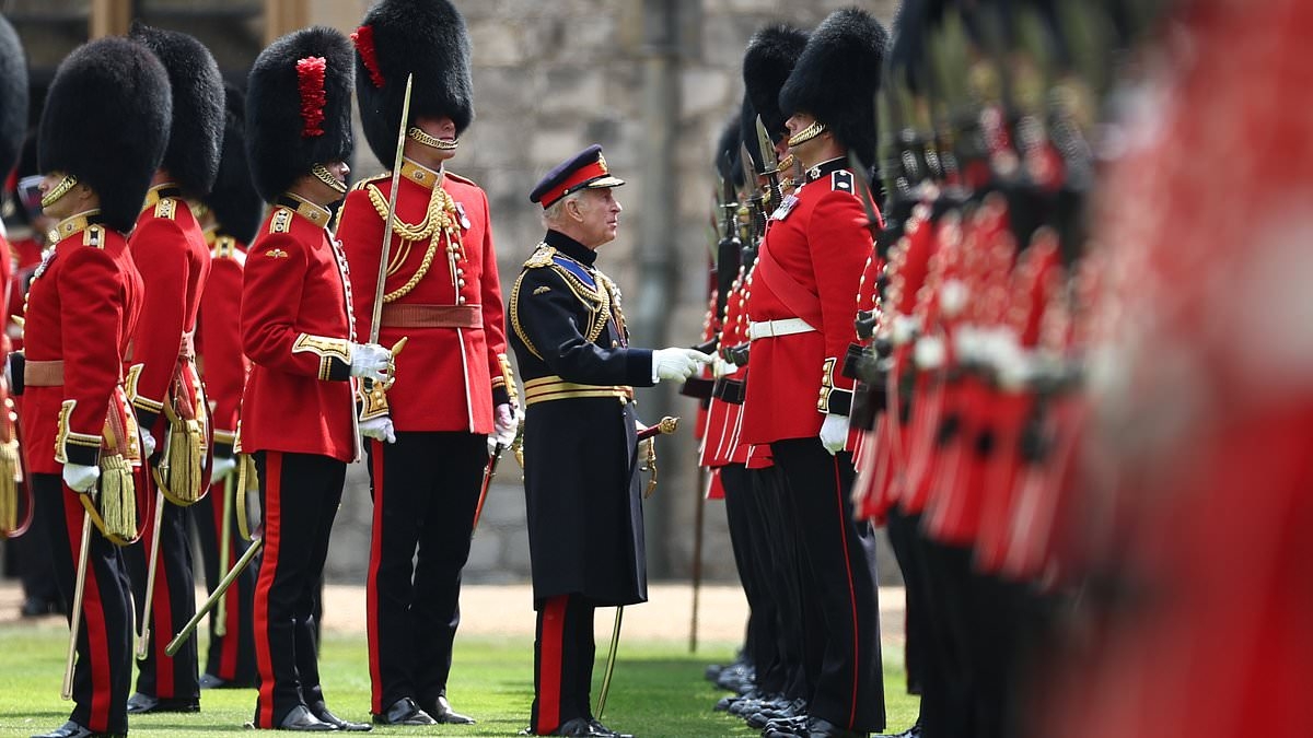 Like toy soldiers! Minuscule monarch is dwarfed by King's Guard as he inspects troops ahead of birthday parade