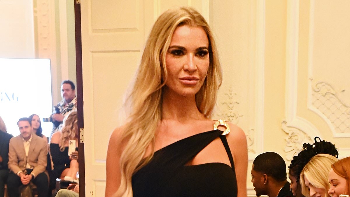 Christine McGuinness puts on a very leggy display in a black mini dress as she struts down the runway at the Models Of Diversity: Fashioning Change event