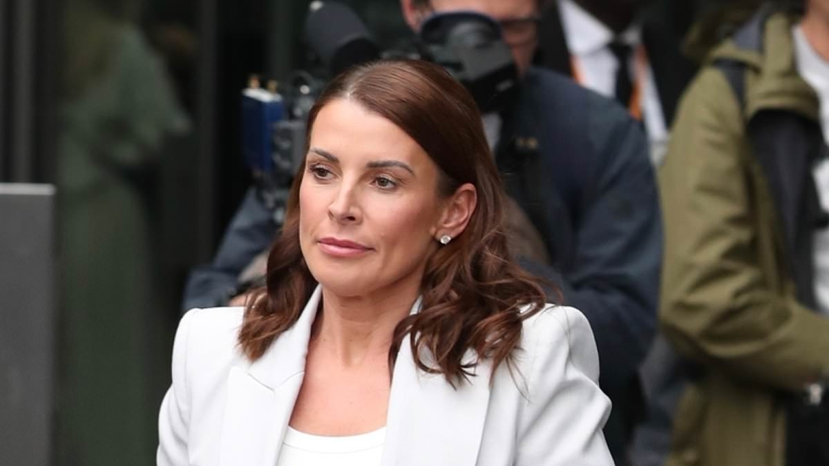 Coleen Rooney looks effortlessly chic in a grey blazer and trousers as she's spotted leaving hotel to visit husband Wayne ahead of Soccer Aid match
