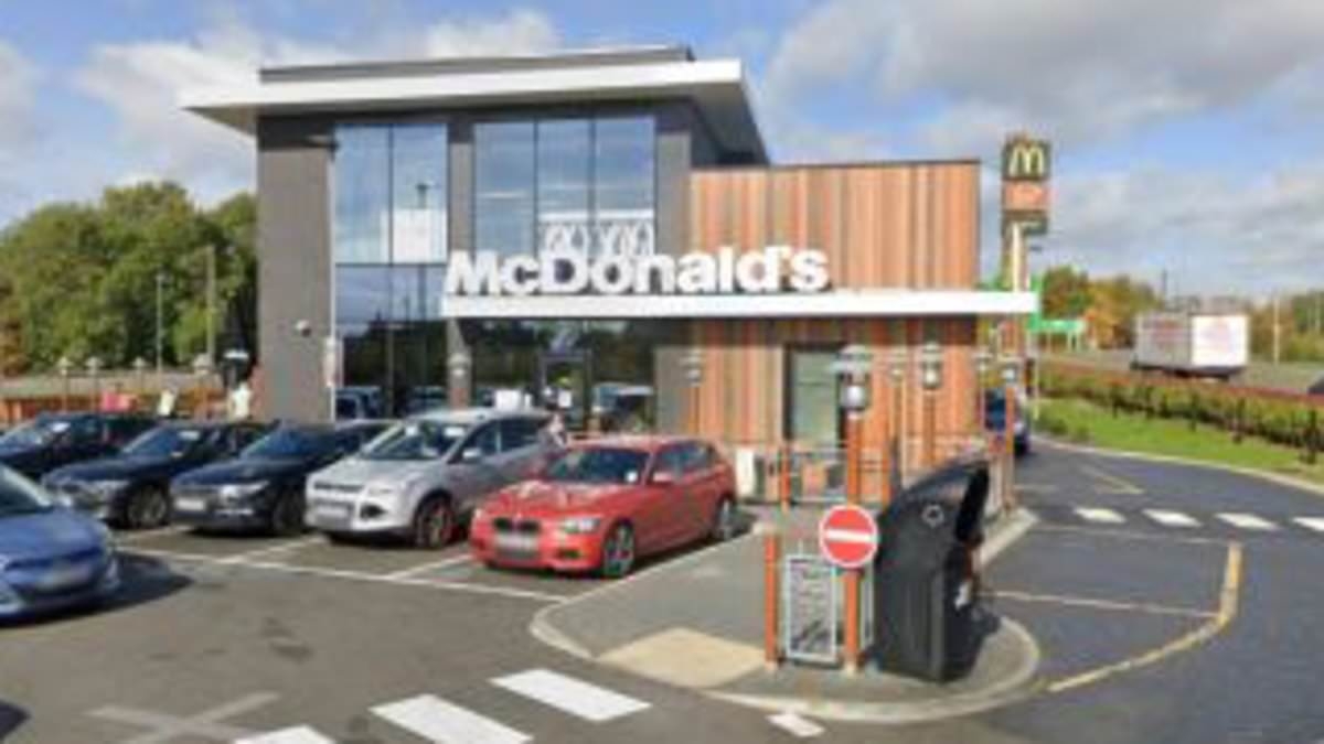 Man who crashed into McDonald's is arrested on suspicion of murder after dead woman in her 30s is later found in home