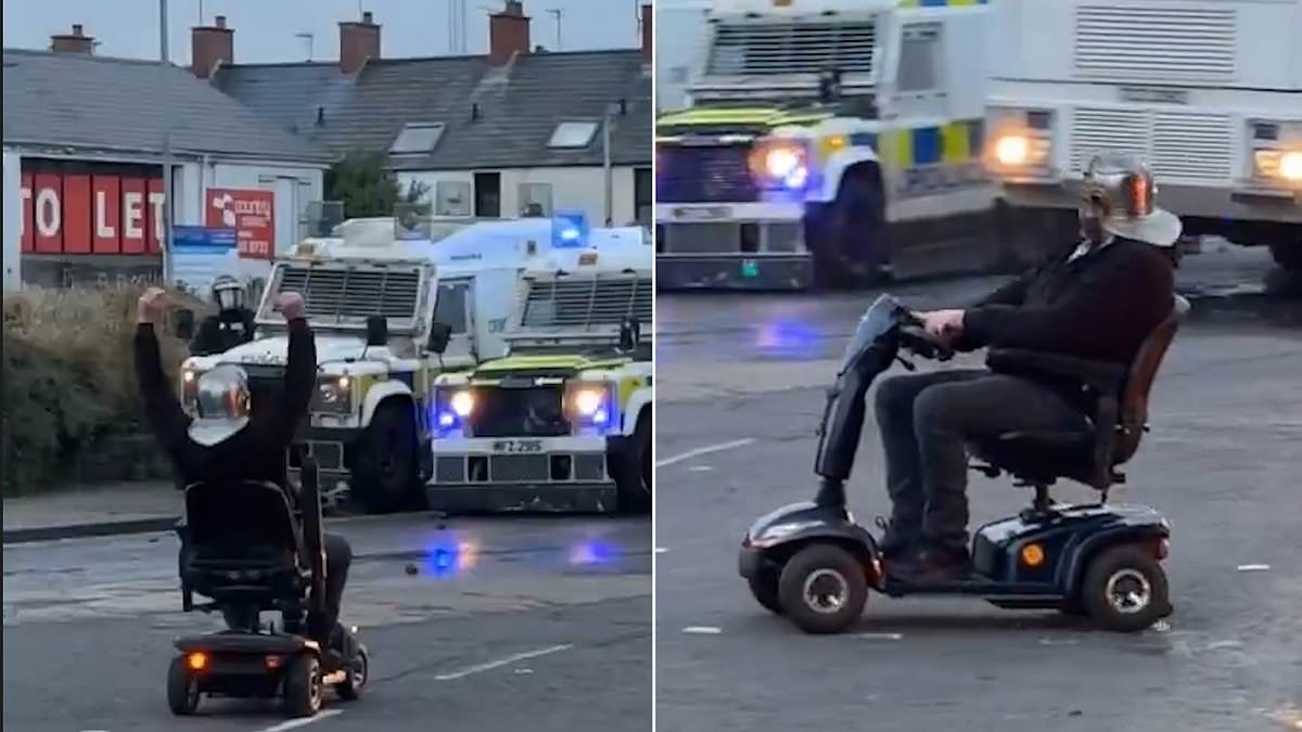 Elderly man challenges riot police on his mobility scooter while wearing a Roman helmet in Ballymena