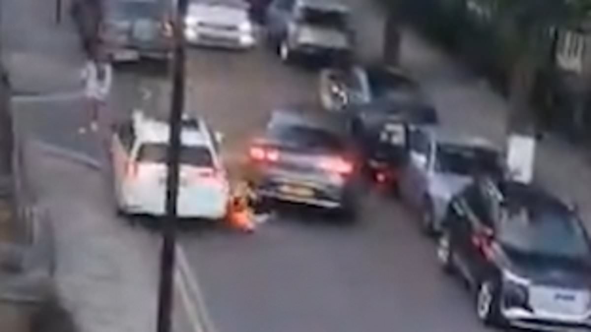 Shocking moment pedestrian is run over by reversing car before being hit AGAIN - as man is arrested over 'attempted murder'