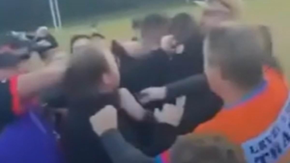 Wild footy brawl kicks off after a woman and man get into physical clash on the sideline following a melee on the field