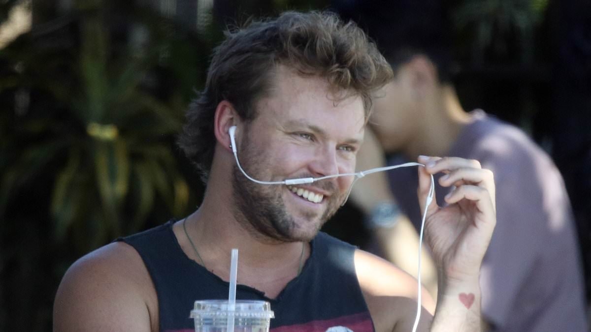Guess who! Aussie heartthrob looks almost unrecognisable while enjoying a low-key lunch in Los Angeles
