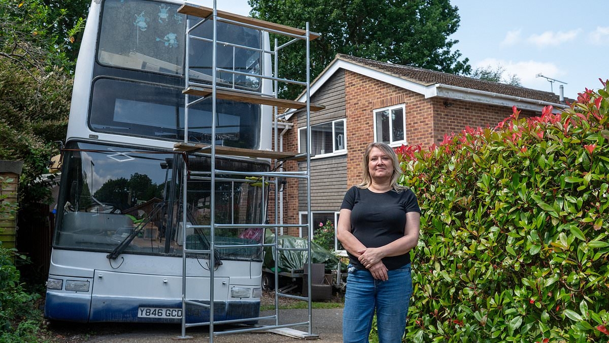 Neighbours at war after mother who parked double-decker bus on her driveway to renovate it was hit by 'ASBO' after snobby complaints
