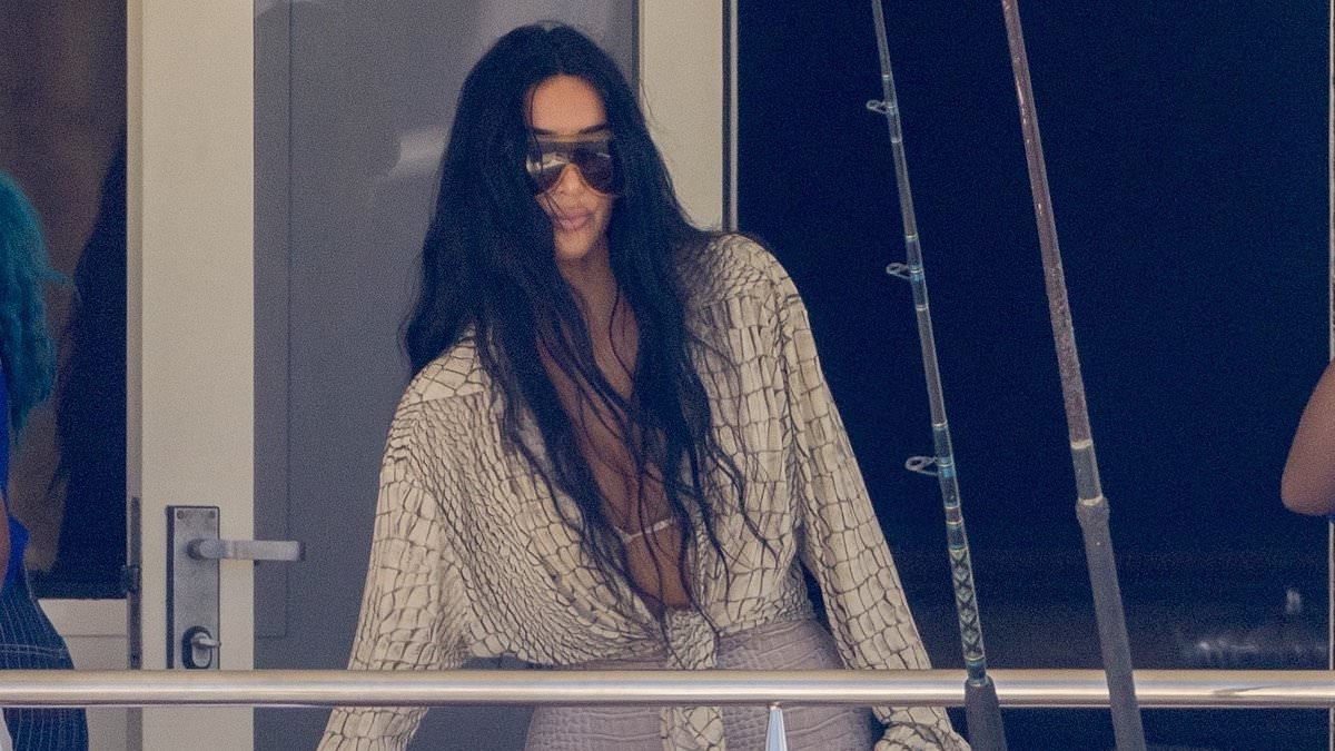 Kim Kardashian shows off her tiny waist in skintight bottoms with bikini top on yacht with daughter North